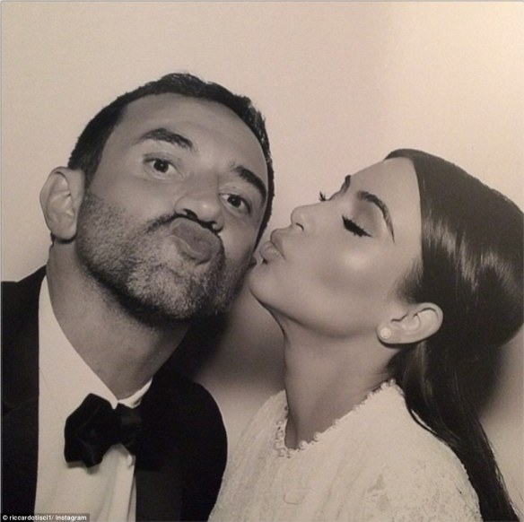 The bride with the designer behind her dress, Riccardo Tisci. 